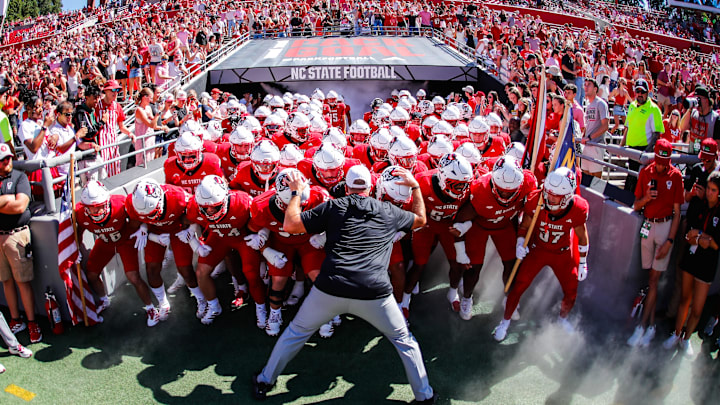 Oct 4, 2025; Raleigh, North Carolina, USA;  NC State Wolfpack head coach Dave Doeren with his team prepare to run out prior to the first half of the game against Campbell Fighting Camels at Carter-Finley Stadium. Mandatory Credit: Jaylynn Nash-Imagn Images