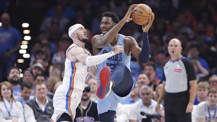 Mar 27, 2025; Oklahoma City, Oklahoma, USA; Oklahoma City Thunder guard Alex Caruso (9) defends a pass by Memphis Grizzlies forward Jaren Jackson Jr. (13) during the second quarter at Paycom Center. Mandatory Credit: Alonzo Adams-Imagn Images
