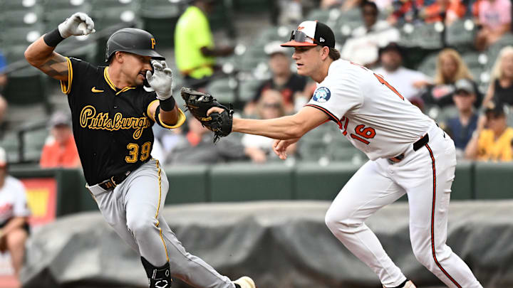 Sep 11, 2025; Baltimore, Maryland, USA;  Pittsburgh Pirates second baseman Nick Gonzales (39) attempts to avoid the tag by Baltimore Orioles first baseman Coby Mayo (16) during the first inning at Oriole Park at Camden Yards. Mandatory Credit: James A. Pittman-Imagn Images