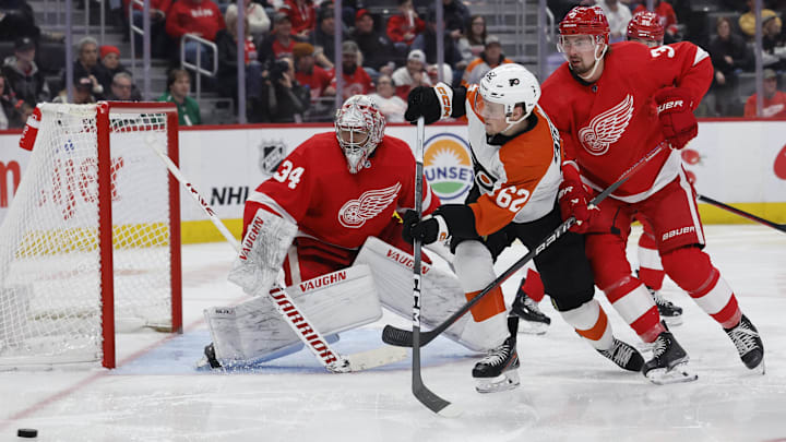Philadelphia Flyers right wing Olle Lycksell (62) battles for the puck in front of the Detroit Red Wings net and goaltender Alex Lyon (34). 