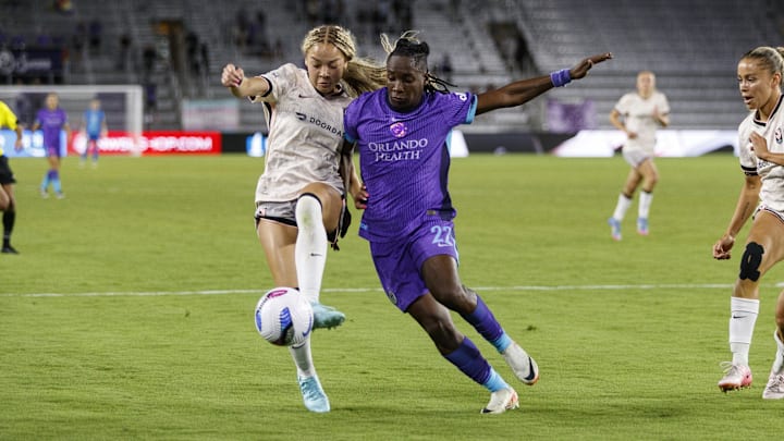 Apr 25, 2025; Orlando, Florida, USA; Angel City FC defender Savy King (3) defends Orlando Pride forward Barbra Banda (22) during the second half at Inter&Co Stadium. Mandatory Credit: Morgan Tencza-Imagn Images