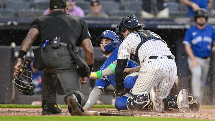 Sep 6, 2025; Bronx, New York, USA; New York Yankees catcher Austin Wells (28) tags out Toronto Blue Jays shortstop Bo Bichette (11) at home plate during the sixth inning at Yankee Stadium.