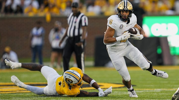 Sep 21, 2024; Columbia, Missouri, USA; Vanderbilt Commodores tight end Eli Stowers (9) runs with the ball past Missouri Tigers safety Tre'Vez Johnson (4) during the second half at Faurot Field at Memorial Stadium. Mandatory Credit: Jay Biggerstaff-Imagn Images