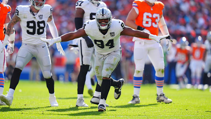 Oct 6, 2024; Denver, Colorado, USA; Las Vegas Raiders defensive tackle Christian Wilkins (94) celebrates his sack in the second quarter against the Denver Broncos at Empower Field at Mile High. Mandatory Credit: Ron Chenoy-Imagn Images