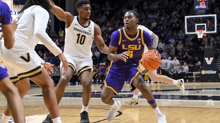 Jan 10, 2026; Nashville, Tennessee, USA; Louisiana State Tigers guard Rashad King (4) drives to the basket past Vanderbilt Commodores forward Ak Okereke (10) during the first half at Memorial Gymnasium. Mandatory Credit: Steve Roberts-Imagn Images
