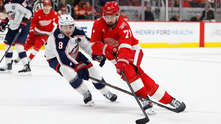 Apr 7, 2026; Detroit, Michigan, USA; Detroit Red Wings center Dylan Larkin (71) skates with the puck in overtime defended by Columbus Blue Jackets defenseman Zach Werenski (8) at Little Caesars Arena. Mandatory Credit: Rick Osentoski-Imagn Images Apr 7, 2026; Detroit, Michigan, USA; Detroit Red Wings center Dylan Larkin (71) skates with the puck in overtime defended by Columbus Blue Jackets defenseman Zach Werenski (8) at Little Caesars Arena. Mandatory Credit: Rick Osentoski-Imagn Images
