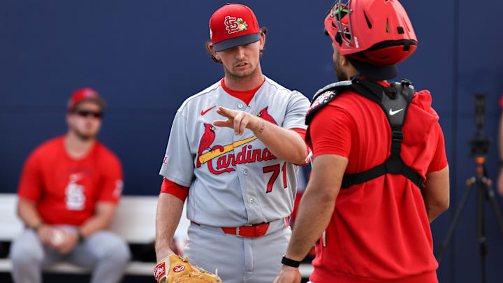 Feb 14, 2026; Jupiter, FL, USA; St. Louis Cardinals pitcher Packy Naughton (71) speaks to catcher Ivan Herrera (48) during a spring training workout at Roger Dean Chevrolet Stadium. Mandatory Credit: Sam Navarro-Imagn Images