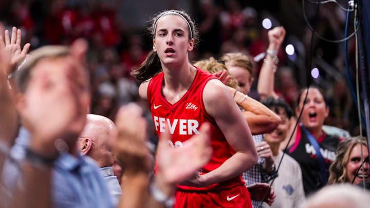 Indiana Fever guard Caitlin Clark (22) celebrates with fans behind the basket Friday, Aug. 16, 2024, during the game at Gainbridge Fieldhouse in Indianapolis.o