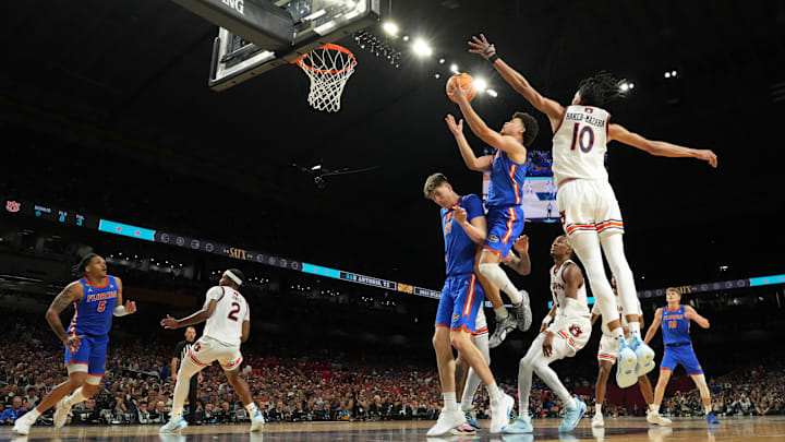 Apr 5, 2025; San Antonio, TX, USA; Florida Gators guard Walter Clayton Jr. (1) shoots the ball over forward Alex Condon (21) against Auburn Tigers guard Chad Baker-Mazara (10) during the second half in the semifinals of the men's Final Four of the 2025 NCAA Tournament at the Alamodome. Mandatory Credit: Bob Donnan-Imagn Images