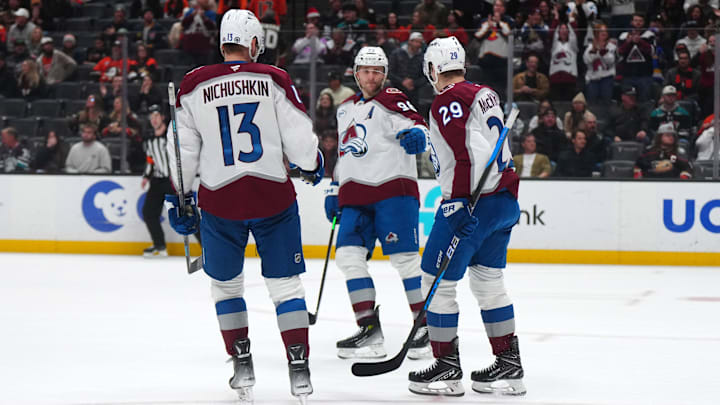 Dec 20, 2024; Anaheim, California, USA; Colorado Avalanche right wing Valeri Nichushkin (13), right wing Mikko Rantanen (96) and center Nathan MacKinnon (29) celebrate after an empty net goal against the Anaheim Ducks in the third period at Honda Center. Mandatory Credit: Kirby Lee-Imagn Images