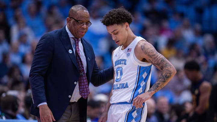 Dec 22, 2025; Chapel Hill, North Carolina, USA; North Carolina Tar Heels head coach Hubert Davis talks with guard Kyan Evans (0) during the first half against the East Carolina Pirates at Dean E. Smith Center. Mandatory Credit: Scott Kinser-Imagn Images