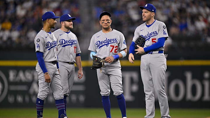 Apr 20, 2025; Arlington, Texas, USA; Los Angeles Dodgers shortstop Mookie Betts (50) and second baseman Miguel Rojas (72) and first baseman Freddie Freeman (5) and third baseman Max Muncy (13) during the game between the Texas Rangers and the Los Angeles Dodgers at Globe Life Field. Mandatory Credit: Jerome Miron-Imagn Images