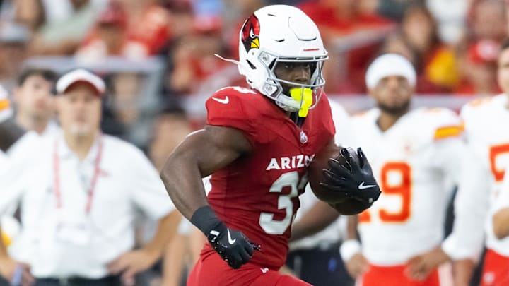 Aug 9, 2025; Glendale, Arizona, USA; Arizona Cardinals running back Trey Benson (33) against the Kansas City Chiefs during a preseason NFL game at State Farm Stadium. Aug 9, 2025; Glendale, Arizona, USA; Arizona Cardinals running back Trey Benson (33) against the Kansas City Chiefs during a preseason NFL game at State Farm Stadium.