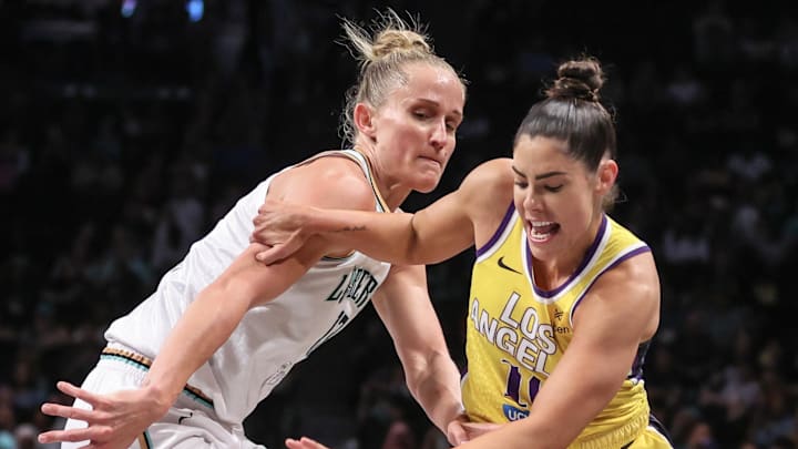 Jul 3, 2025; Brooklyn, New York, USA;  Los Angeles Sparks guard Kelsey Plum (10) and New York Liberty forward Leonie Fiebich (13) fight for a loose ball in the first quarter at Barclays Center. Mandatory Credit: Wendell Cruz-Imagn Images