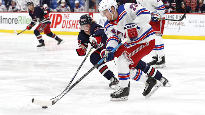 Feb 11, 2020; Winnipeg, Manitoba, CAN;  Winnipeg Jets right wing Patrik Laine (29) checks New York Rangers defenseman Adam Fox (23) in the second period at Bell MTS Place. Mandatory Credit: James Carey Lauder-USA TODAY Sports