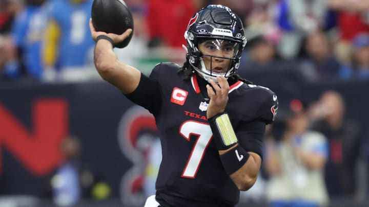 Houston Texans quarterback C.J. Stroud (7) looks to pass during the first quarter against the Los Angeles Chargers in an AFC wild card game at NRG Stadium.