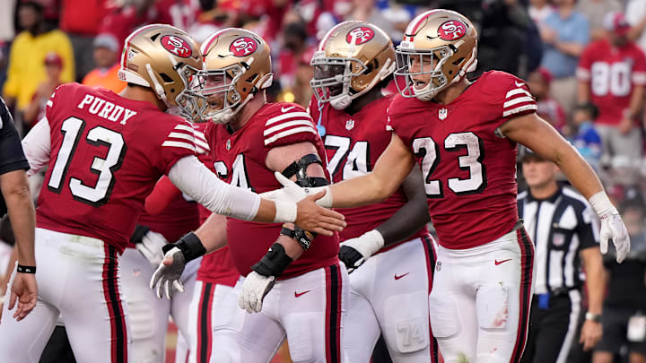 San Francisco 49ers quarterback Brock Purdy (13) congratulations running back Christian McCaffrey (23)