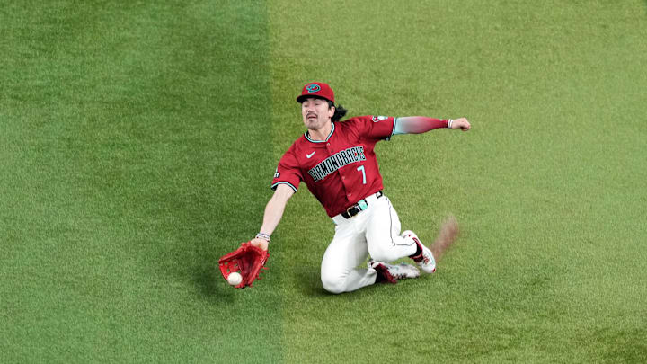 Sep 28, 2024; Phoenix, Arizona, USA; Arizona Diamondbacks outfielder Corbin Carroll (7) is unable to make a sliding catch against the San Diego Padres during the third inning at Chase Field. Mandatory Credit: Joe Camporeale-Imagn Images