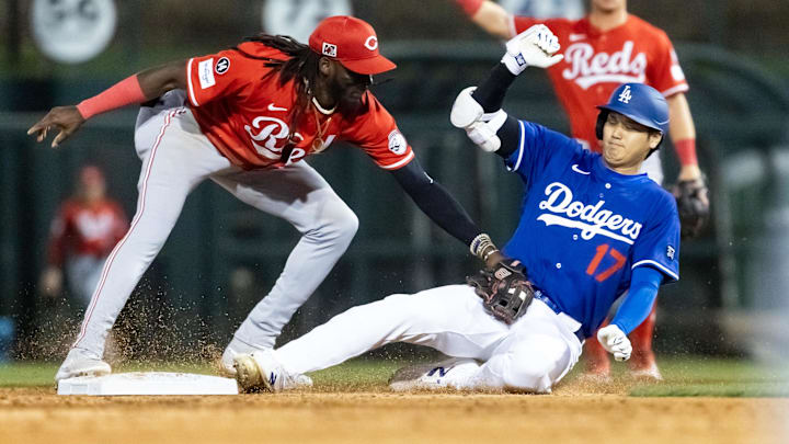 Mar 4, 2025; Phoenix, Arizona, USA; Los Angeles Dodgers designated hitter Shohei Ohtani is tagged out at second base by Cincinnati Reds shortstop Elly De La Cruz during a spring training game at Camelback Ranch-Glendale. Mandatory Credit: Mark J. Rebilas-Imagn Images