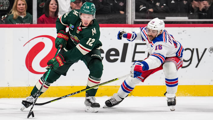 Oct 13, 2022; Saint Paul, Minnesota, USA; New York Rangers center Vincent Trocheck (16) pokes the puck away from Minnesota Wild left wing Matt Boldy (12) during the second period at Xcel Energy Center. Mandatory Credit: Brace Hemmelgarn-Imagn Images