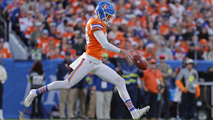 Jan 4, 2026; Denver, Colorado, USA; Denver Broncos punter Jeremy Crawshaw (16) punts the ball during the game against the Los Angeles Chargers during the first half at Empower Field at Mile High. Mandatory Credit: Isaiah J. Downing-Imagn Images