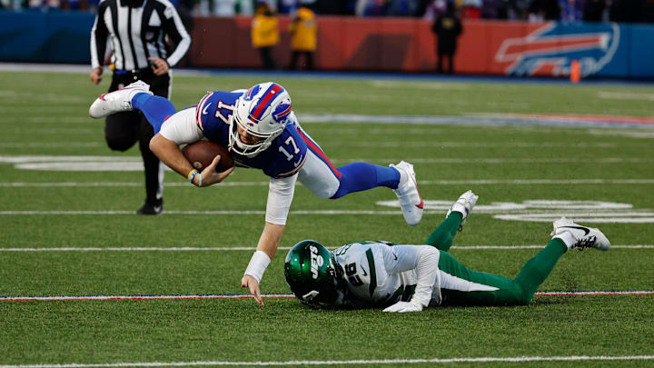 Buffalo Bills quarterback Josh Allen (17) is tackled by New York Jets Brandin Echols (26) after a short gain.