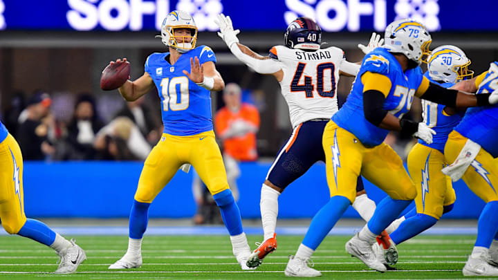 Chargers QB Justin Herbert attempts a pass against the Broncos