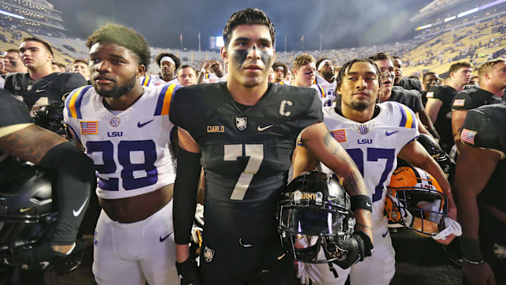 Oct 21, 2023; Baton Rouge, Louisiana, USA; Army Black Knights linebacker Jimmy Ciarlo (7) stands with LSU Tigers running back Kaleb Jackson (28) and LSU Tigers running back Josh Williams (27) during the West Point alma mater