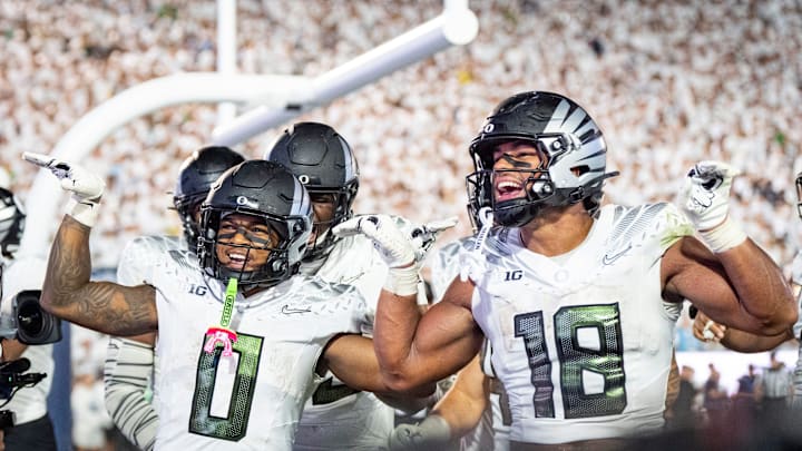 Oregon Ducks running back Jordon Davison, left and Oregon tight end Kenyon Sadiq celebrate a touchdown by Davison as the Oregon Ducks face the Penn State Nittany Lions on Sept. 27, 2025, at Beaver Stadium in University Park, Pennsylvania.