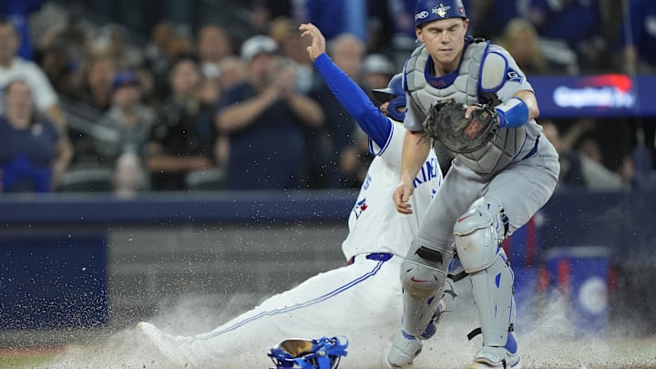 Nov 1, 2025; Toronto, Ontario, CAN; Toronto Blue Jays second baseman Isiah Kiner-Falefa (7) is out against Los Angeles Dodgers catcher Will Smith (16) in the ninth inning during game seven of the 2025 MLB World Series at Rogers Centre. Mandatory Credit: John E. Sokolowski-Imagn Images