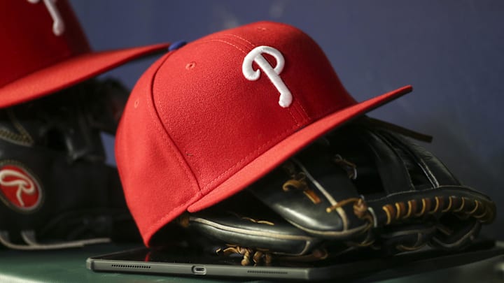 May 25, 2022; Atlanta, Georgia, USA; Detailed view of a Philadelphia Phillies hat and glove in the dugout against the Atlanta Braves in the eighth inning at Truist Park. Mandatory Credit: Brett Davis-Imagn Images