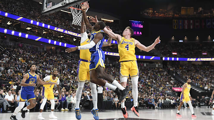 Oct 15, 2024; Las Vegas, Nevada, USA; Golden State Warriors forward Jonathan Kuminga (00) shoots against Los Angeles Lakers center Anthony Davis (3) and guard Dalton Knecht (4) in the second quarter during a preseason game at T-Mobile Arena. Mandatory Credit: Candice Ward-Imagn Images
