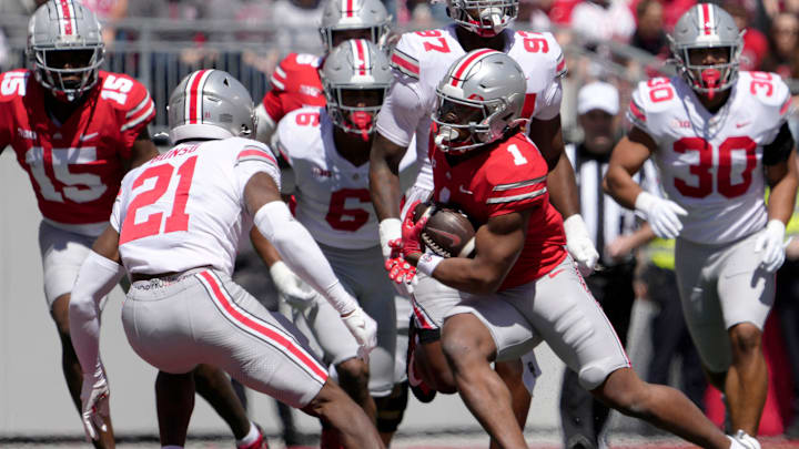 April 13, 2024; Columbus, Ohio, USA; 
Ohio State Buckeyes running back Quinshon Judkins (1) runs the football for the scarlet team while pursued by safety Jayden Bonsu (21) of the grey team during the first half of the LifeSports spring football game at Ohio Stadium on Saturday.