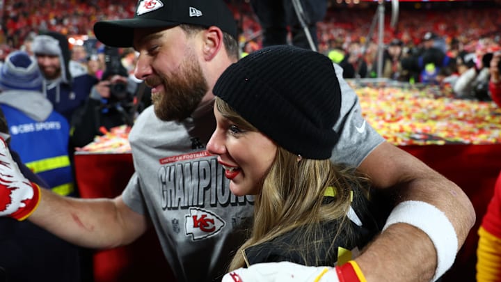 Recording artist Taylor Swift  and Kansas City Chiefs tight end Travis Kelce (87) react after the AFC Championship game against the Buffalo Bills at GEHA Field at Arrowhead Stadium.