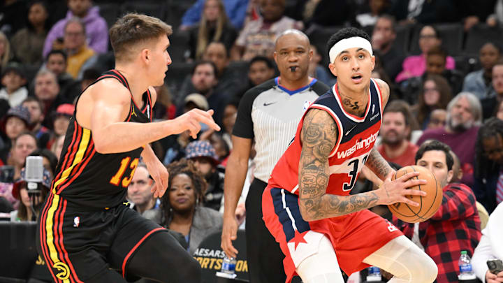Dec 31, 2023; Washington, District of Columbia, USA;  Washington Wizards forward Kyle Kuzma (33) looks to the basket as Atlanta Hawks guard Bogdan Bogdanovic (13) defends during the second half at Capital One Arena. Mandatory Credit: James A. Pittman-USA TODAY Sports