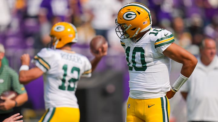 Sep 11, 2022; Minneapolis, Minnesota, USA; Green Bay Packers quarterback Jordan Love (10) watches quarterback Aaron Rodgers (12) warm up before the game against the Minnesota Vikings at U.S. Bank Stadium. Mandatory Credit: Brad Rempel-USA TODAY Sports