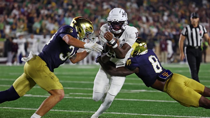 Sep 13, 2025; South Bend, Indiana, USA; Texas A&M Aggies quarterback Marcel Reed (10) runs the ball as Notre Dame Fighting Irish safety Adon Shuler (8) goes for a tackle during the second half at Notre Dame Stadium. Mandatory Credit: Trevor Ruszkowski-Imagn Images