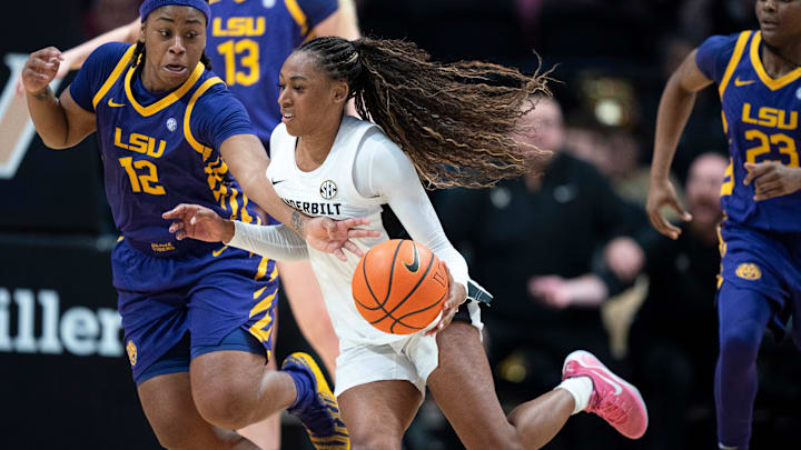 Louisiana State guard Mikaylah Williams (12) fouls a driving Vanderbilt guard Mikayla Blakes (1) during their game at Memorial Gymnasium Sunday, Jan. 4, 2026.