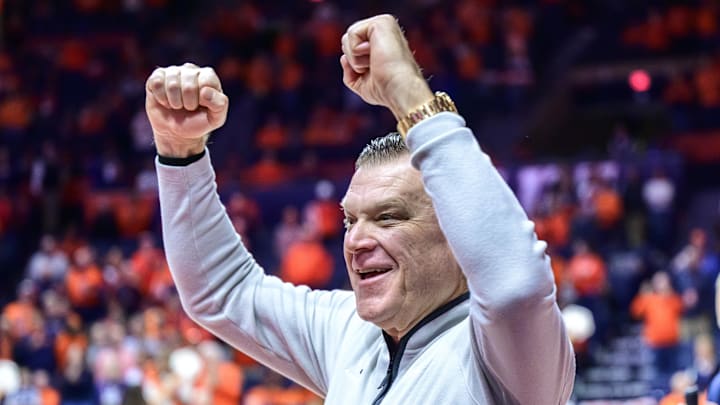 Jan 21, 2026; Champaign, Illinois, USA;  Illinois Fighting Illini head coach Brad Underwood greets fans as he enters the floor during pre-game introductions at State Farm Center in a matchup against the Maryland Terrapins.. Mandatory Credit: Fred Zwicky-Imagn Images