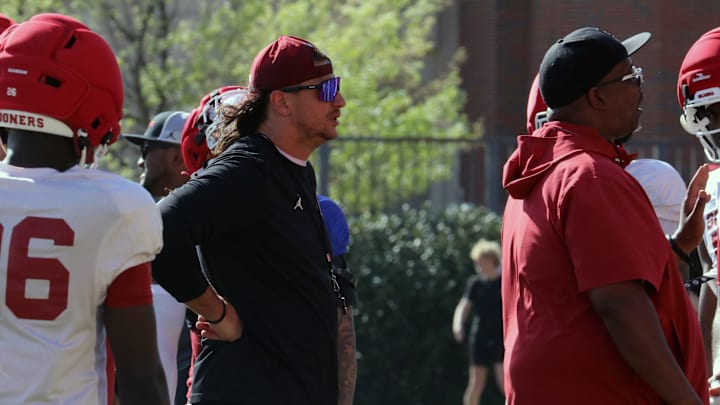 Oklahoma defensive ends coach Miguel Chavis (left) and defensive tackles coach Todd Bates (right) look on during a spring practice. 