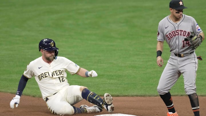 Milwaukee Brewers first base Rhys Hoskins (12) beats the throw to Houston Astros second base Mauricio Dubón (14) after hitting an RBI double during the eighth inning of their game Monday, May 5, 2025 at American Family Field in Milwaukee, Wisconsin.