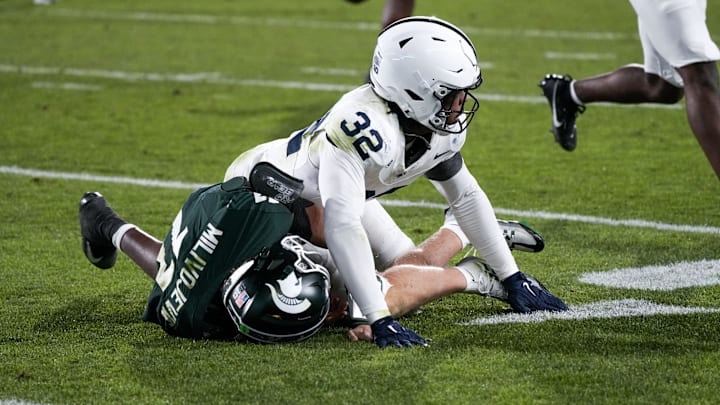 Nov 15, 2025; East Lansing, Michigan, USA; Penn State linebacker Keon Wylie (32) tackles Michigan State quarterback Alessio Milivojevic (11) as the ball is thrown at Spartan Stadium. Mandatory Credit: Brendan Mullin-Imagn Images