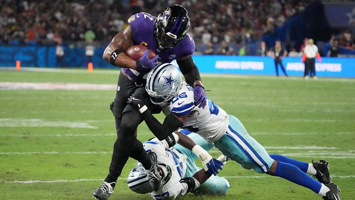 Sep 27, 2026; Rio De Janeiro, BRA; (Editors Notes: Caption Correction)  Baltimore Ravens running back Derrick Henry (22) runs for a touchdown over Dallas Cowboys cornerback DaRon Bland (26) and linebacker Malachi Lawrence (57) during the first quarter at Maracana Stadium.  Mandatory Credit: Kirby Lee-Imagn Images