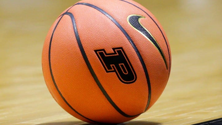 A NCAA women's basketball with the Purdue University logo sits on the court A NCAA women's basketball with the Purdue University logo sits on the court