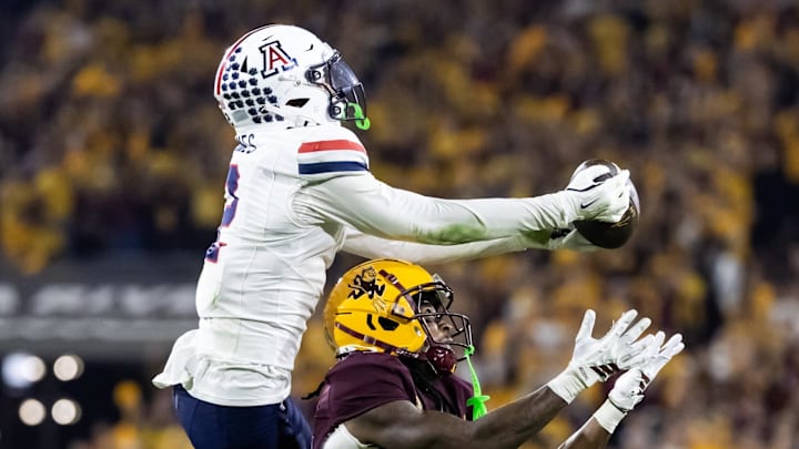 Nov 28, 2025; Tempe, Arizona, USA; Arizona Wildcats defensive back Treydan Stukes (2) intercepts the ball against Arizona State Sun Devils wide receiver Jaren Hamilton (16) in the second half during the 99th Territorial Cup at Mountain America Stadium. Mandatory Credit: Mark J. Rebilas-Imagn Images
