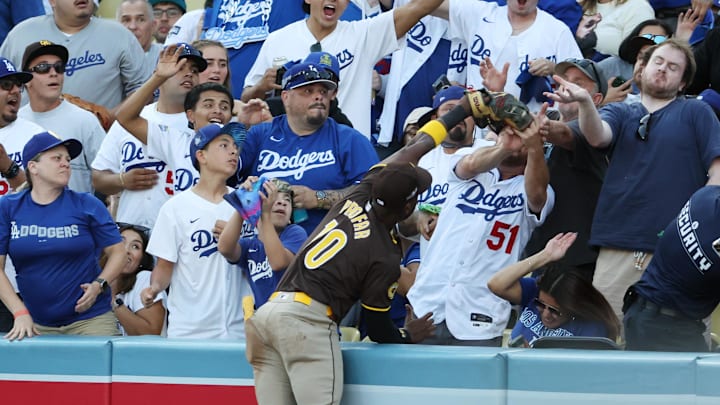Oct 6, 2024; Los Angeles, California, USA; San Diego Padres outfielder Jurickson Profar (10) catches a ball hit by Los Angeles Dodgers shortstop Mookie Betts (50) in the first inning during game two of the NLDS for the 2024 MLB Playoffs at Dodger Stadium. Mandatory Credit: Kiyoshi Mio-Imagn Images