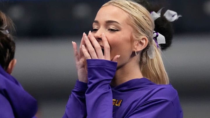 LSU gymnast Livvy Dunne stretches with teammates before Session 2 of the SEC Gymnastics Tournament at Legacy Arena in Birmingham, Alabama.