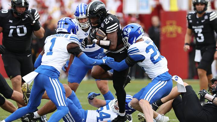 Oct 25, 2025; Ames, Iowa, USA; Iowa State Cyclones running back Abu Sama (24) is tackled by BYU Cougars cornerback Therrian Alexander (1) at Jack Trice Stadium. Mandatory Credit: Reese Strickland-Imagn Images Oct 25, 2025; Ames, Iowa, USA; Iowa State Cyclones running back Abu Sama (24) is tackled by BYU Cougars cornerback Therrian Alexander (1) at Jack Trice Stadium. Mandatory Credit: Reese Strickland-Imagn Images