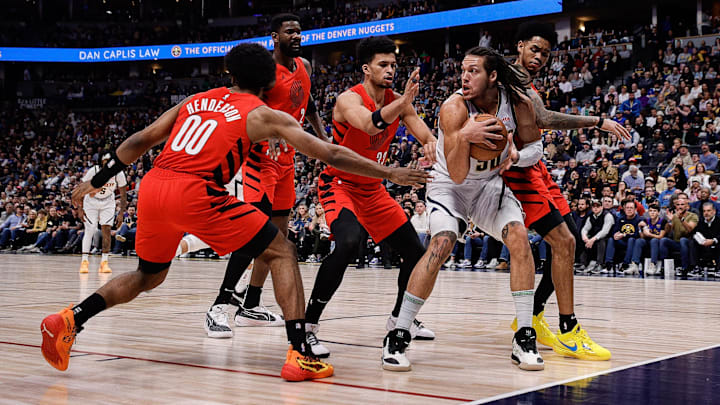 Feb 4, 2024; Denver, Colorado, USA; Denver Nuggets forward Aaron Gordon (50) controls the ball under pressure from Portland Trail Blazers guard Scoot Henderson (00) and center Deandre Ayton (2) and forward Toumani Camara (33) and guard Anfernee Simons (1) in the first quarter at Ball Arena. Mandatory Credit: Isaiah J. Downing-Imagn Images