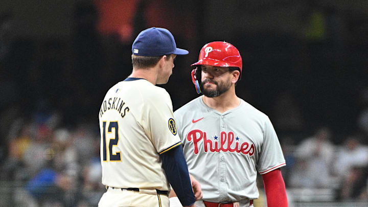 Sep 16, 2024; Milwaukee, Wisconsin, USA; Milwaukee Brewers first base Rhys Hoskins (12) and Philadelphia Phillies designated hitter Kyle Schwarber (12) talk to each other during a pitching change in the sixth inning at American Family Field.